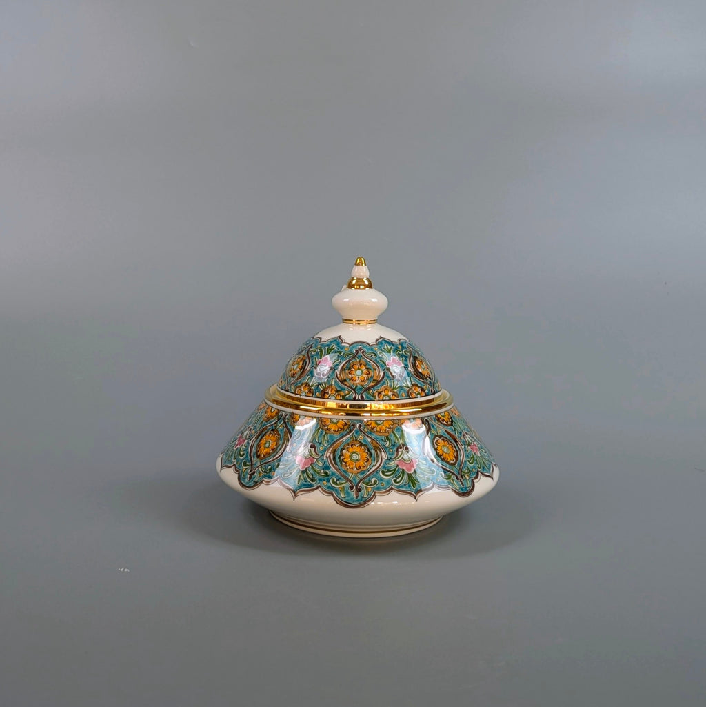 Decorative ceramic pot with intricate designs on a gray background