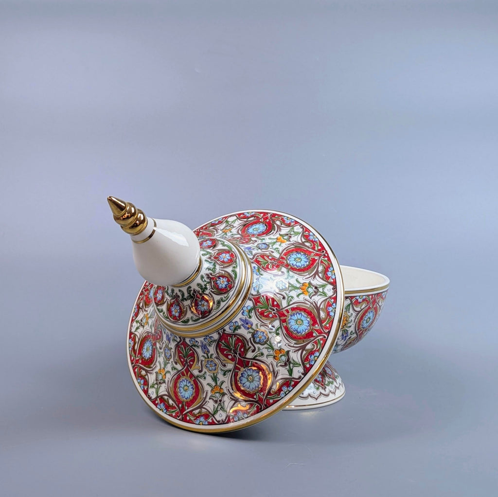 Decorative ceramic teapot with intricate patterns on a gray background