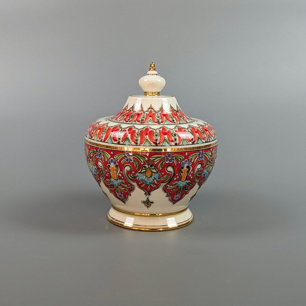 Decorative ceramic jar with colorful patterns on a gray background