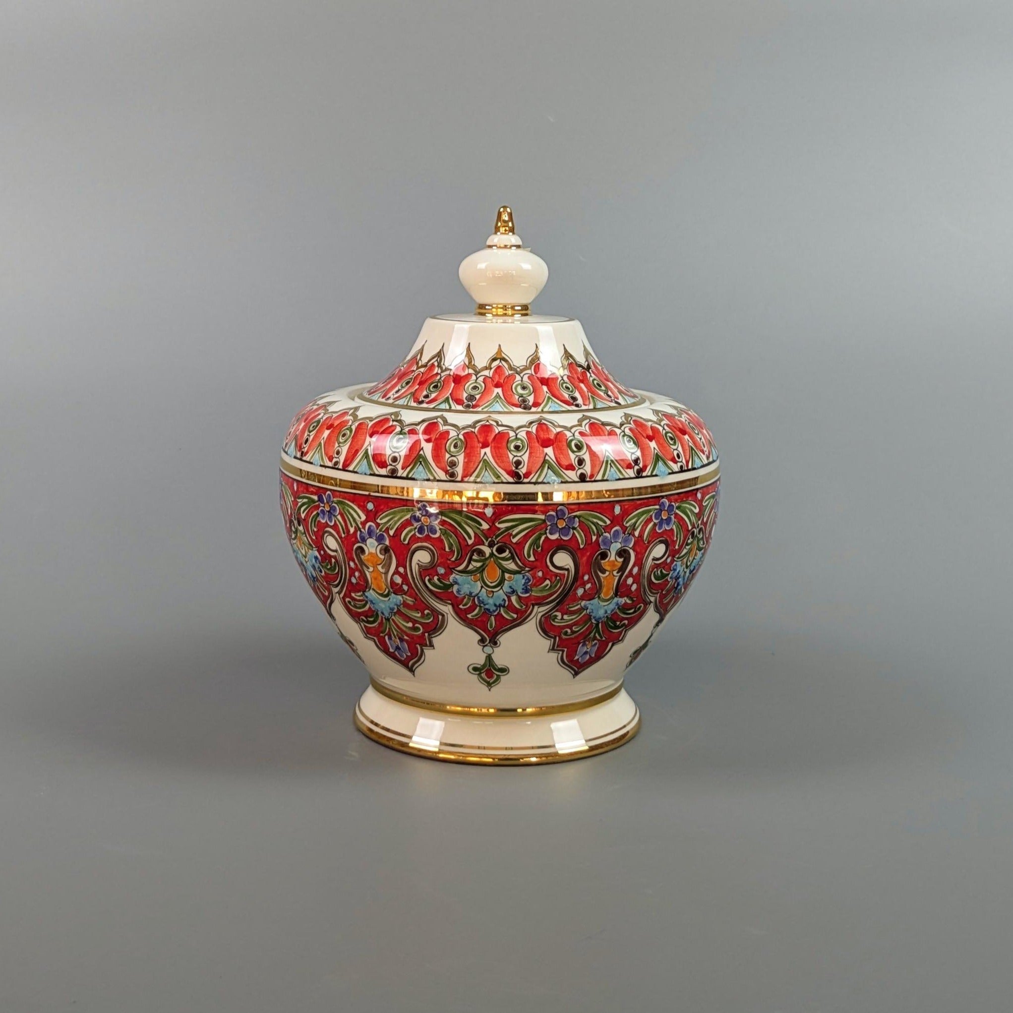 Decorative ceramic jar with colorful patterns on a gray background