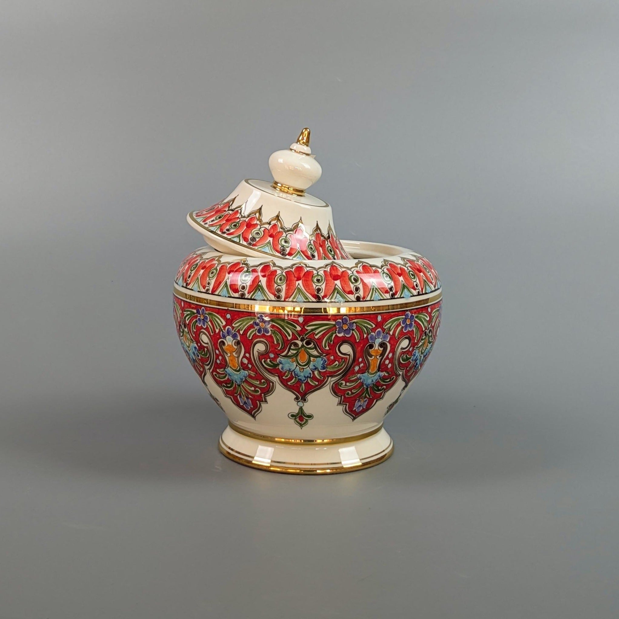 Decorative ceramic jar with colorful patterns on a gray background
