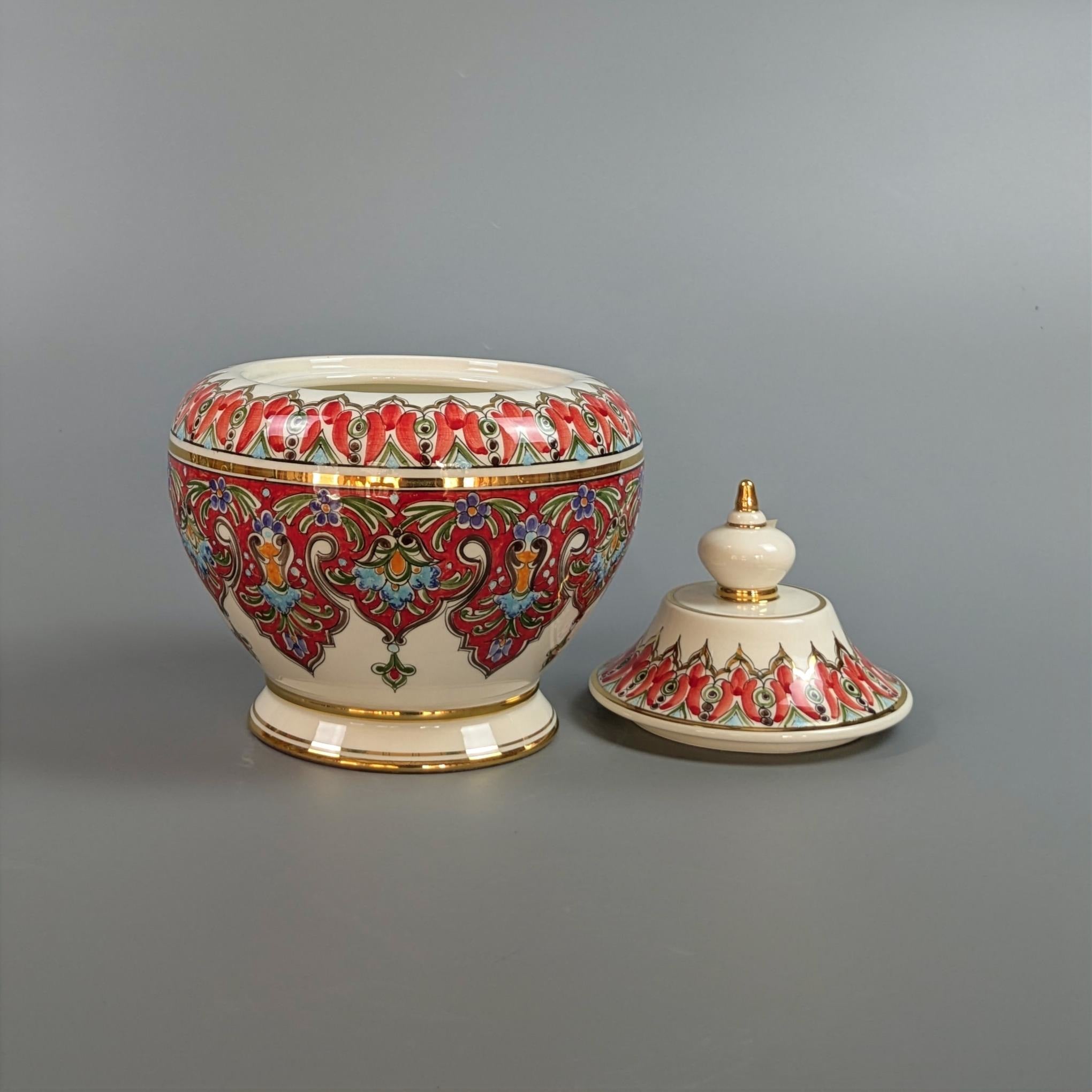Decorative ceramic jar with colorful patterns on a gray background