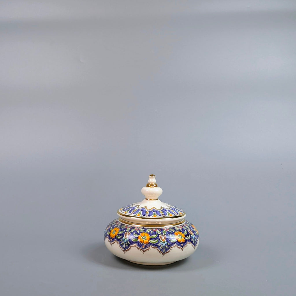 Decorative ceramic jar with floral patterns on a gray background