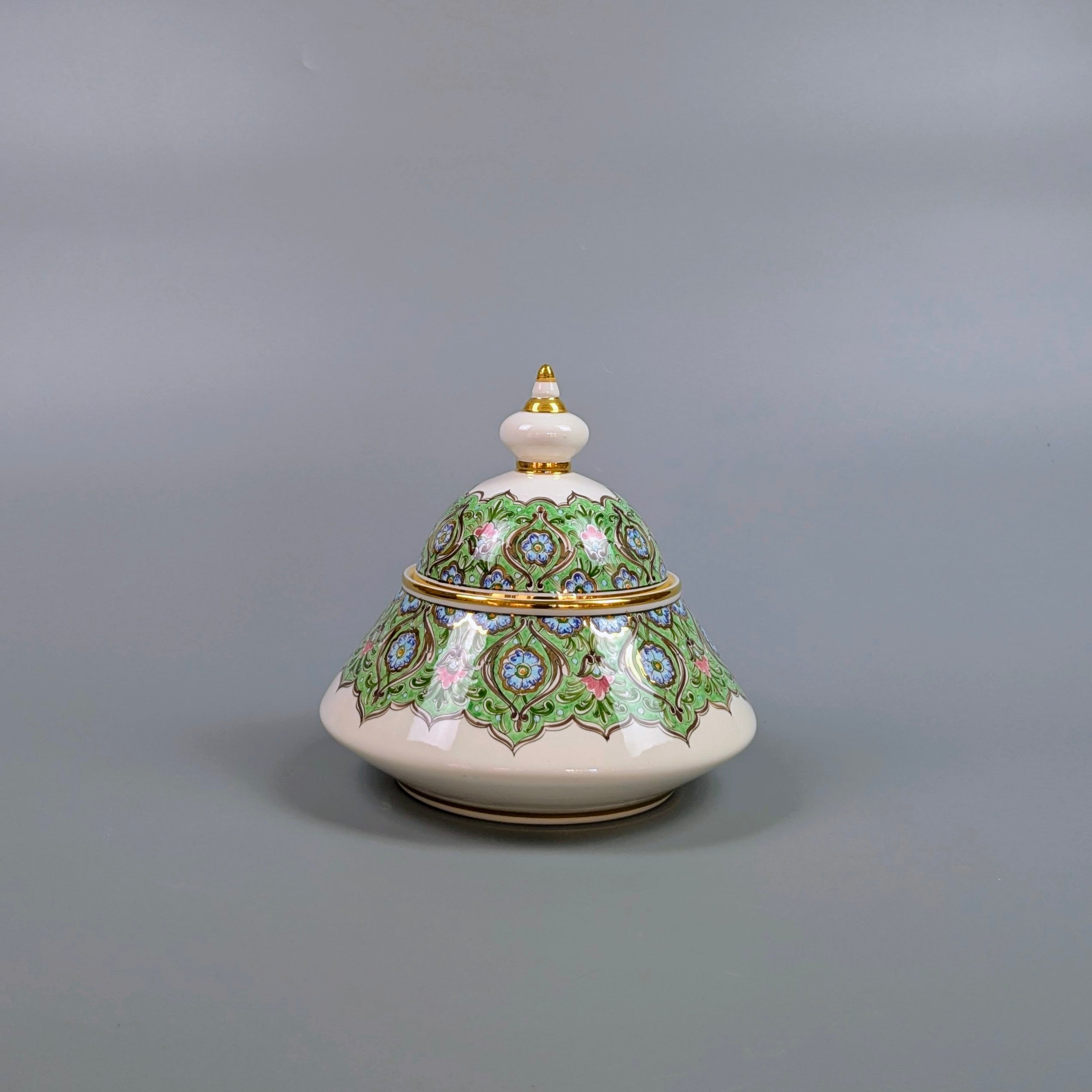 Decorative ceramic piece with intricate designs on a gray background