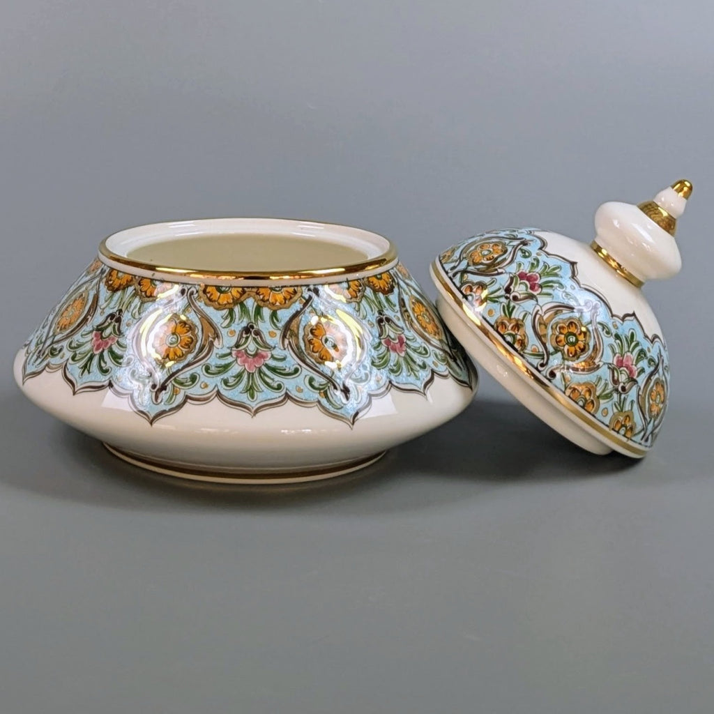 Decorative ceramic jar with lid on a gray background