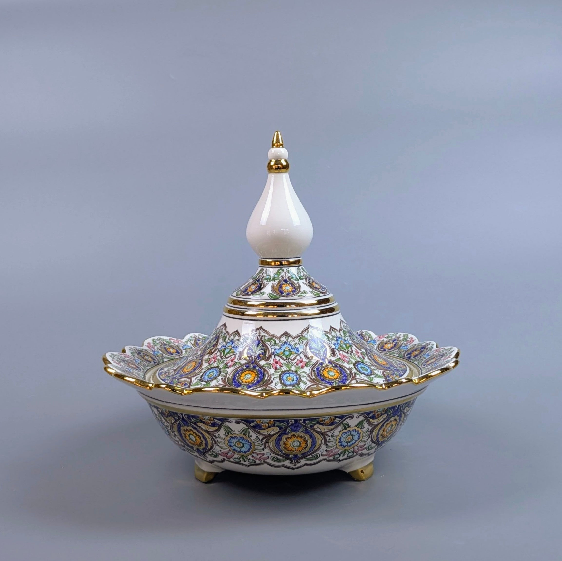 Decorative ceramic dish with intricate patterns on a gray background