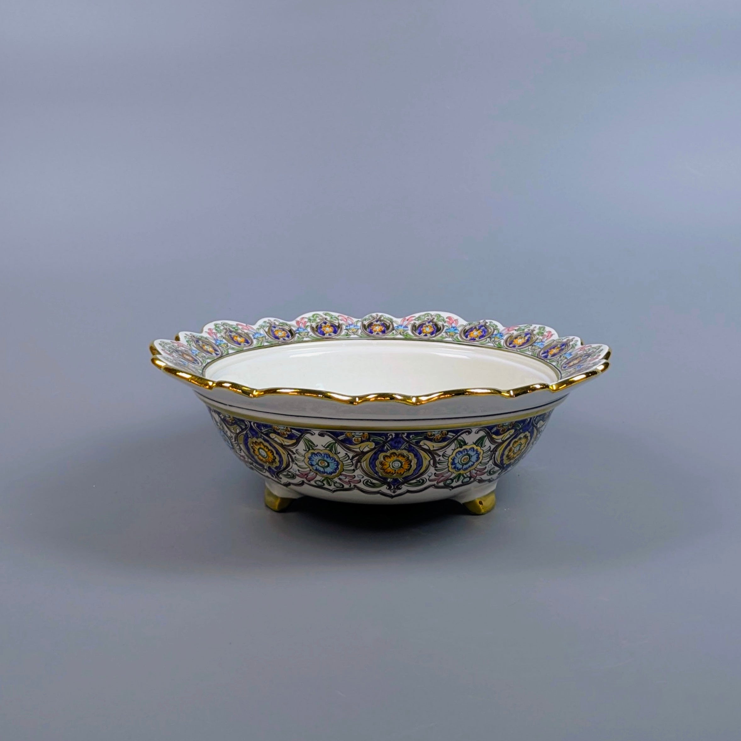 Decorative ceramic bowl with intricate patterns on a gray background
