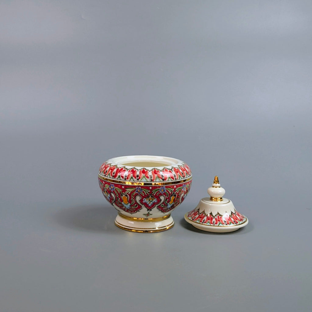 Decorative ceramic bowl with lid on a gray background
