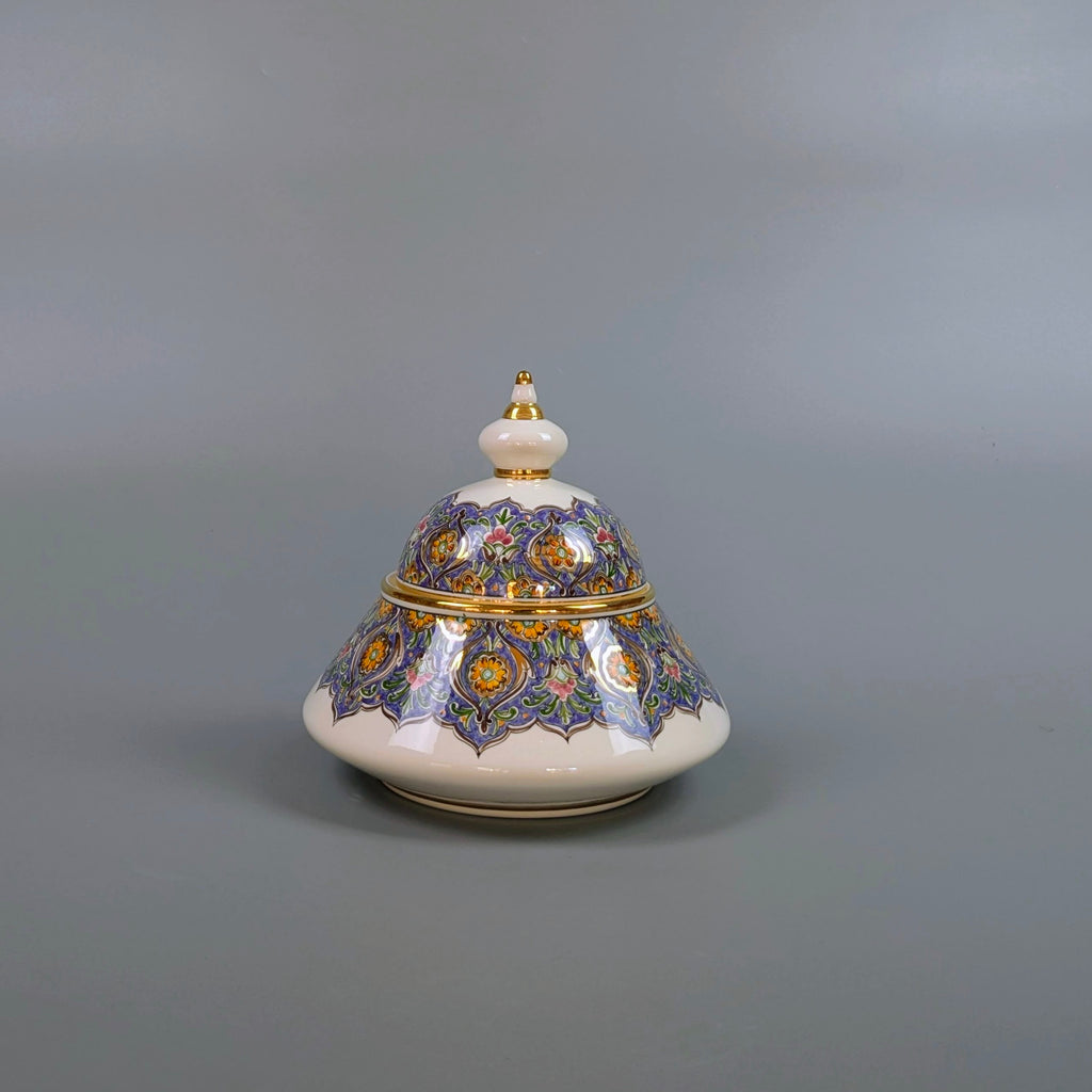 Decorative ceramic pot with a lid on a gray background