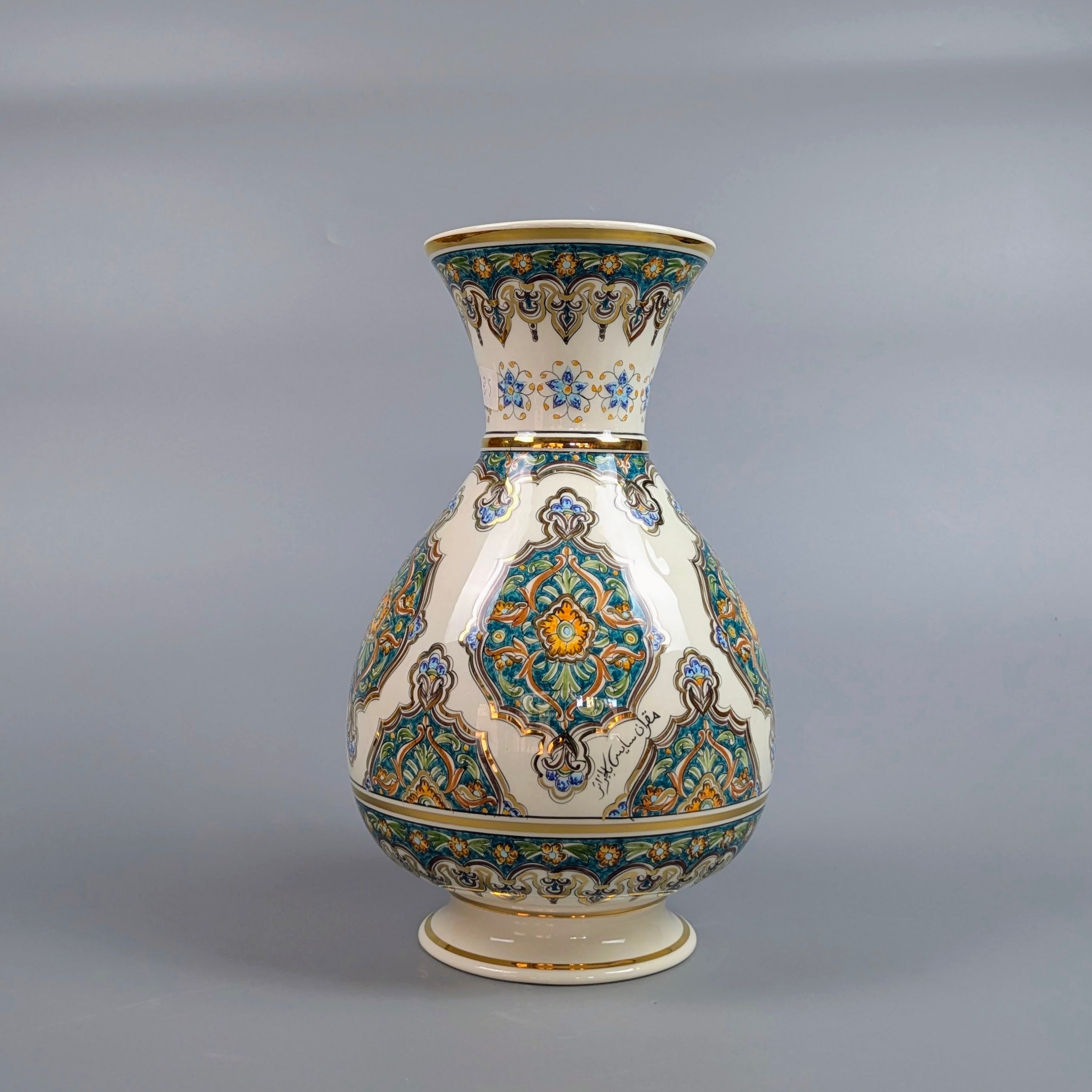 Decorative ceramic vase with intricate patterns on a gray background