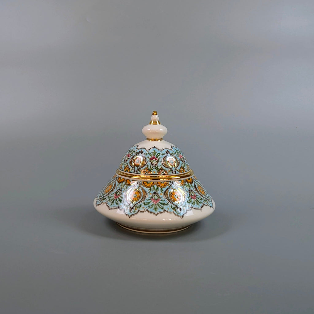 Decorative ceramic pot with lid on a gray background