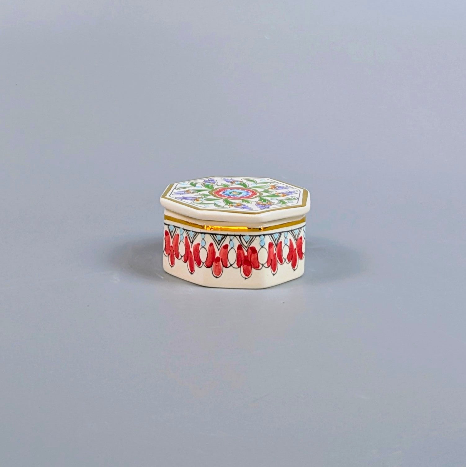 Decorative hexagonal box with colorful patterns on a gray background
