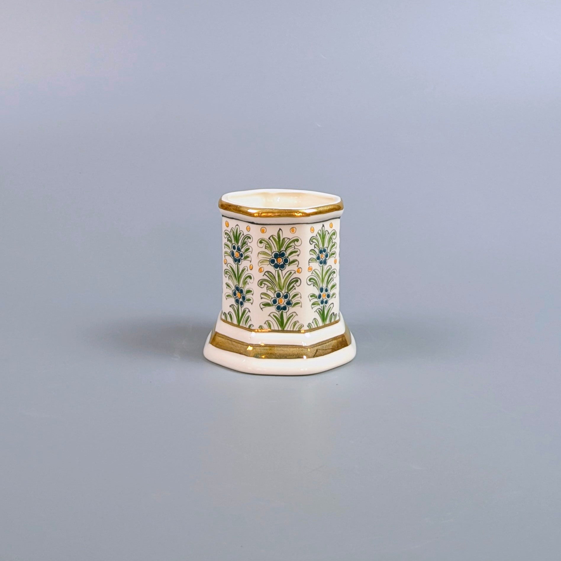 Decorative ceramic vase with floral patterns on a gray background