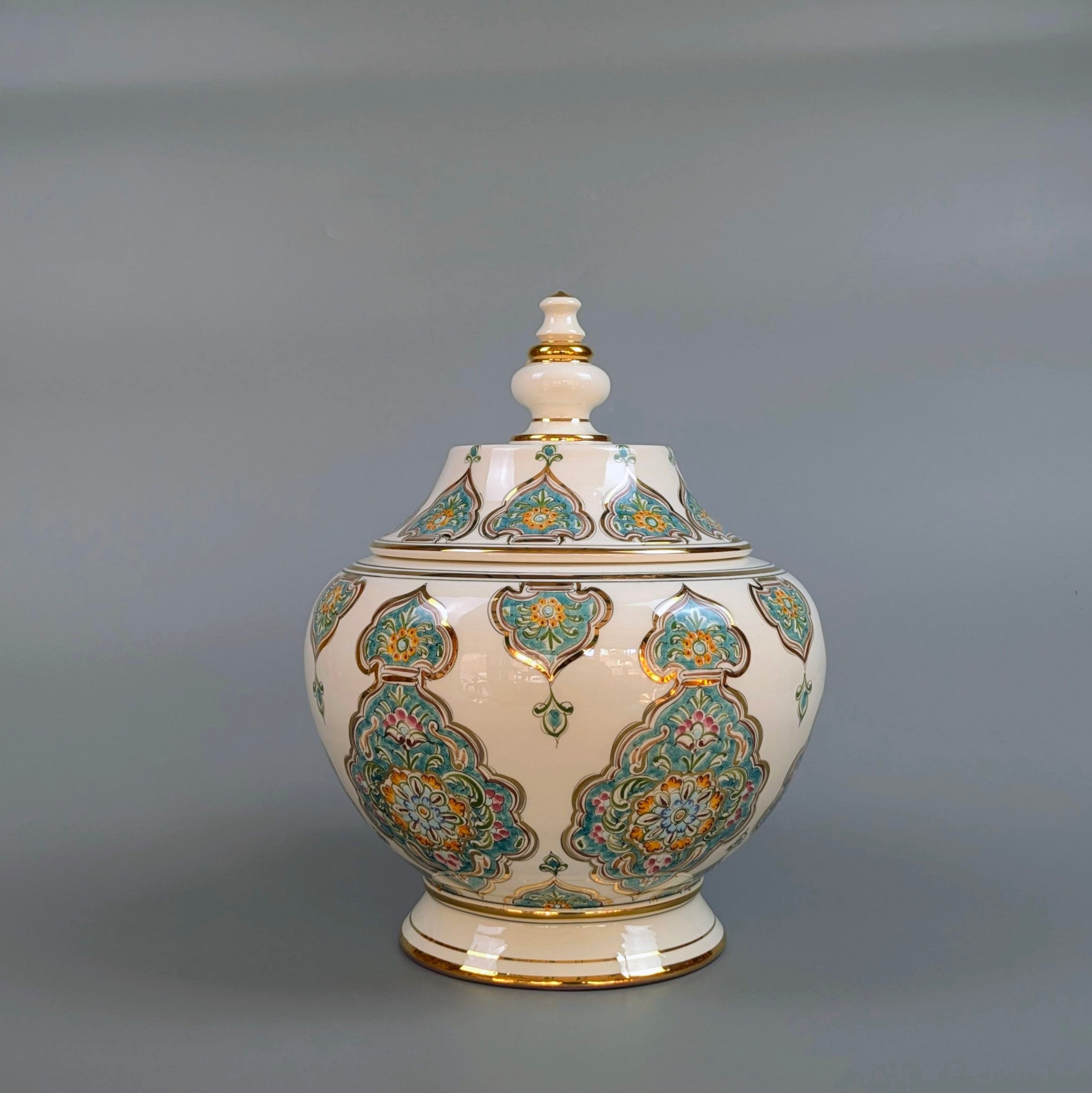 Decorative ceramic jar with intricate patterns on a gray background