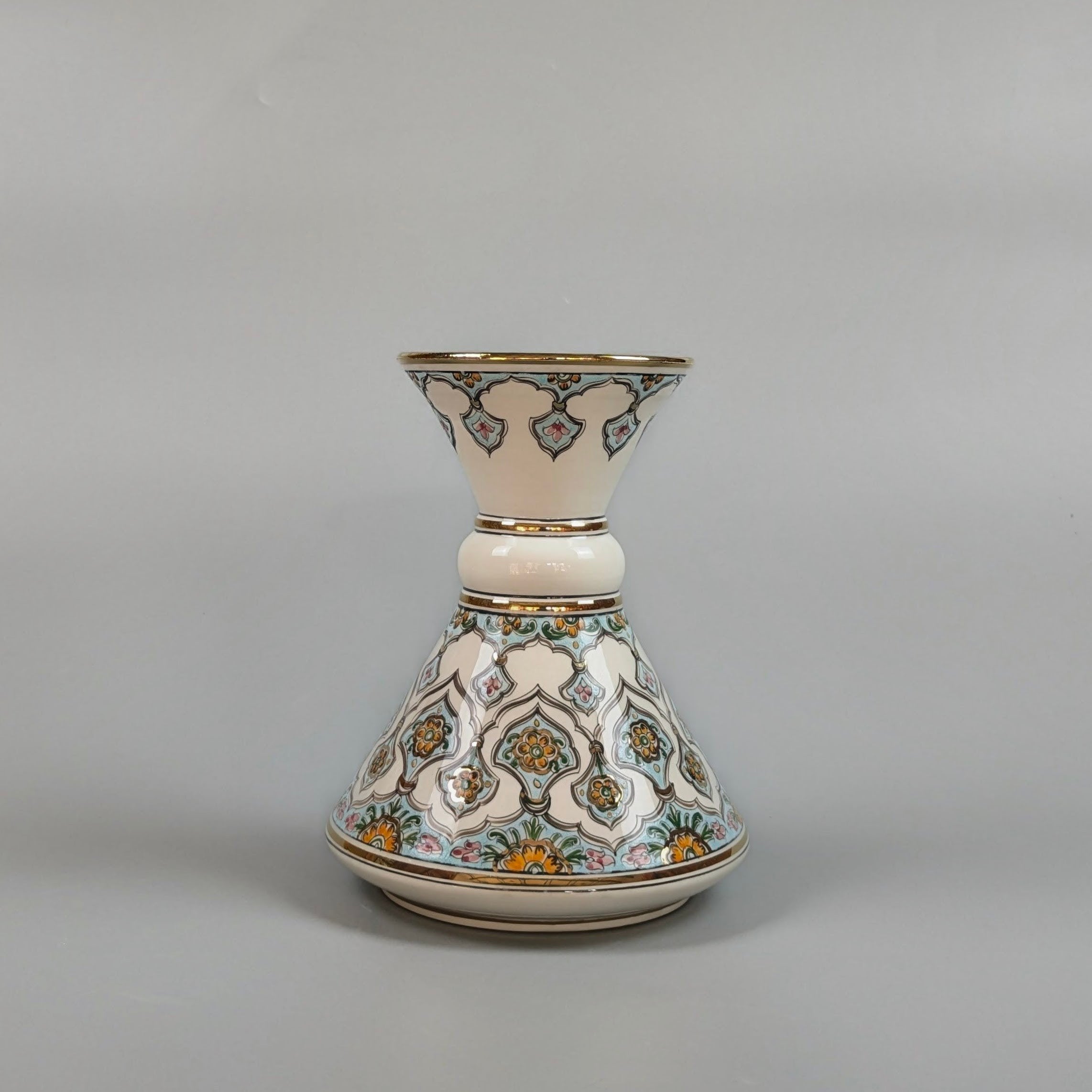 Decorative ceramic vase with intricate patterns on a gray background