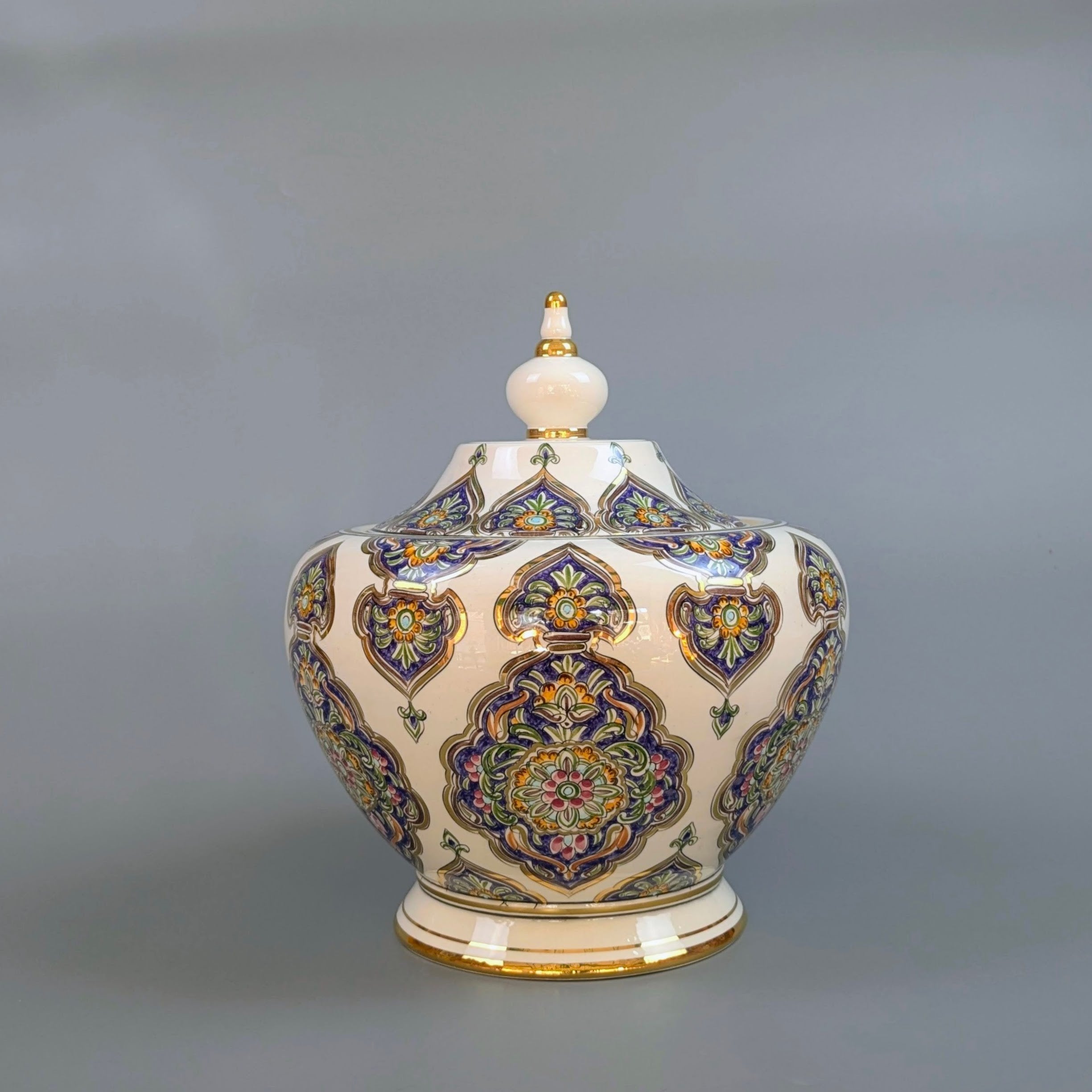 Decorative ceramic jar with intricate patterns on a gray background