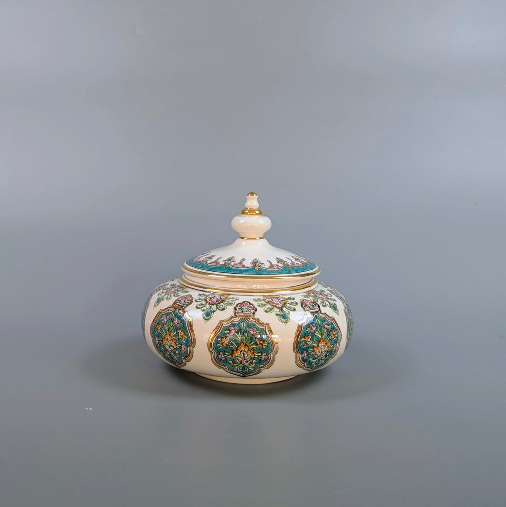 Decorative ceramic jar with a lid on a gray background