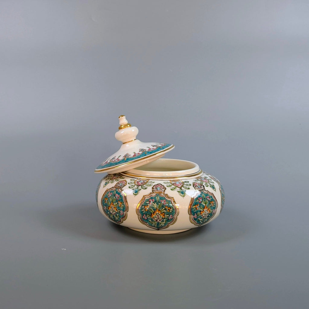 Decorative ceramic jar with floral patterns on a gray background