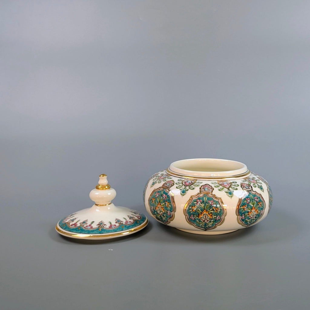 Decorative ceramic jar with lid on a gray background
