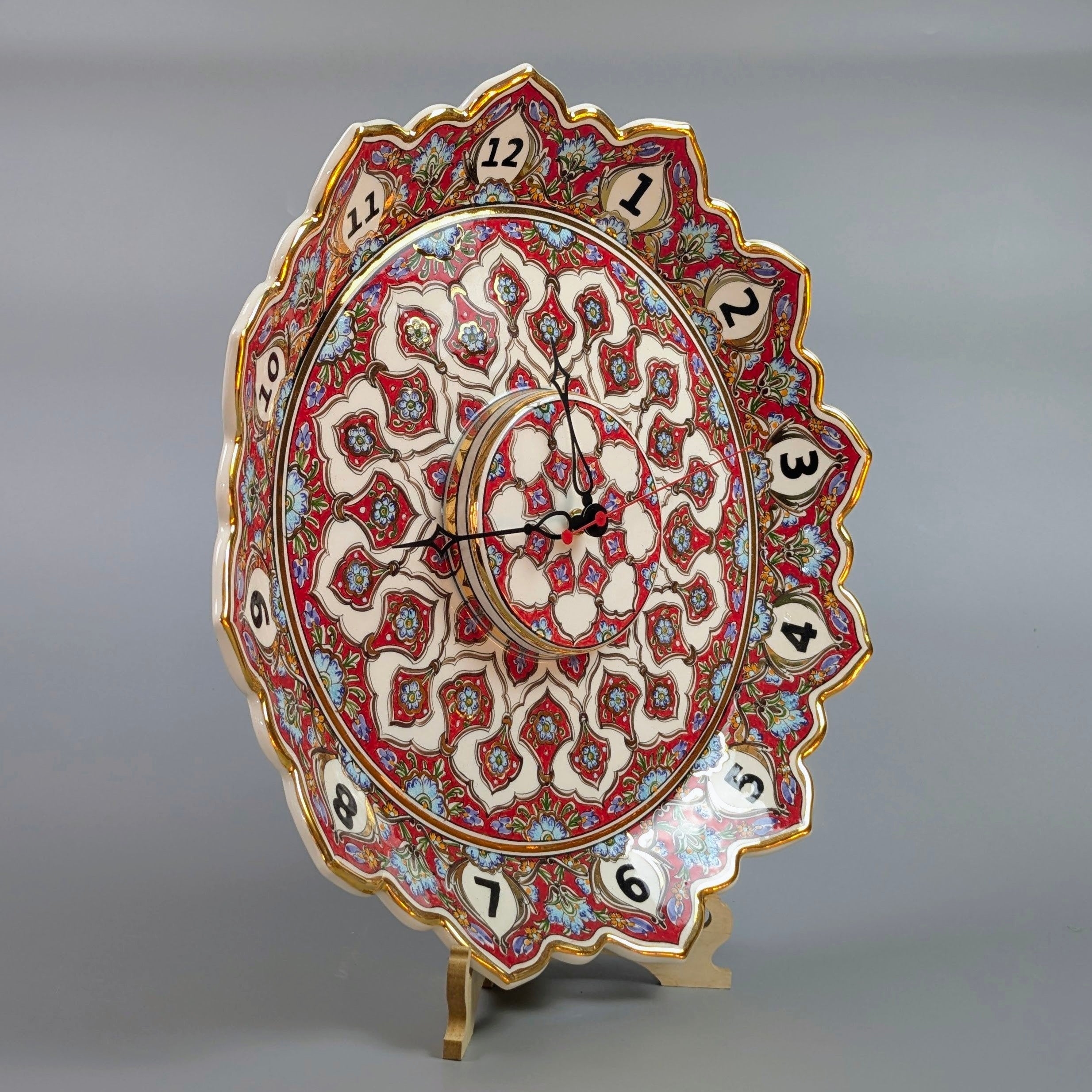 Decorative wall clock with intricate patterns on a gray background
